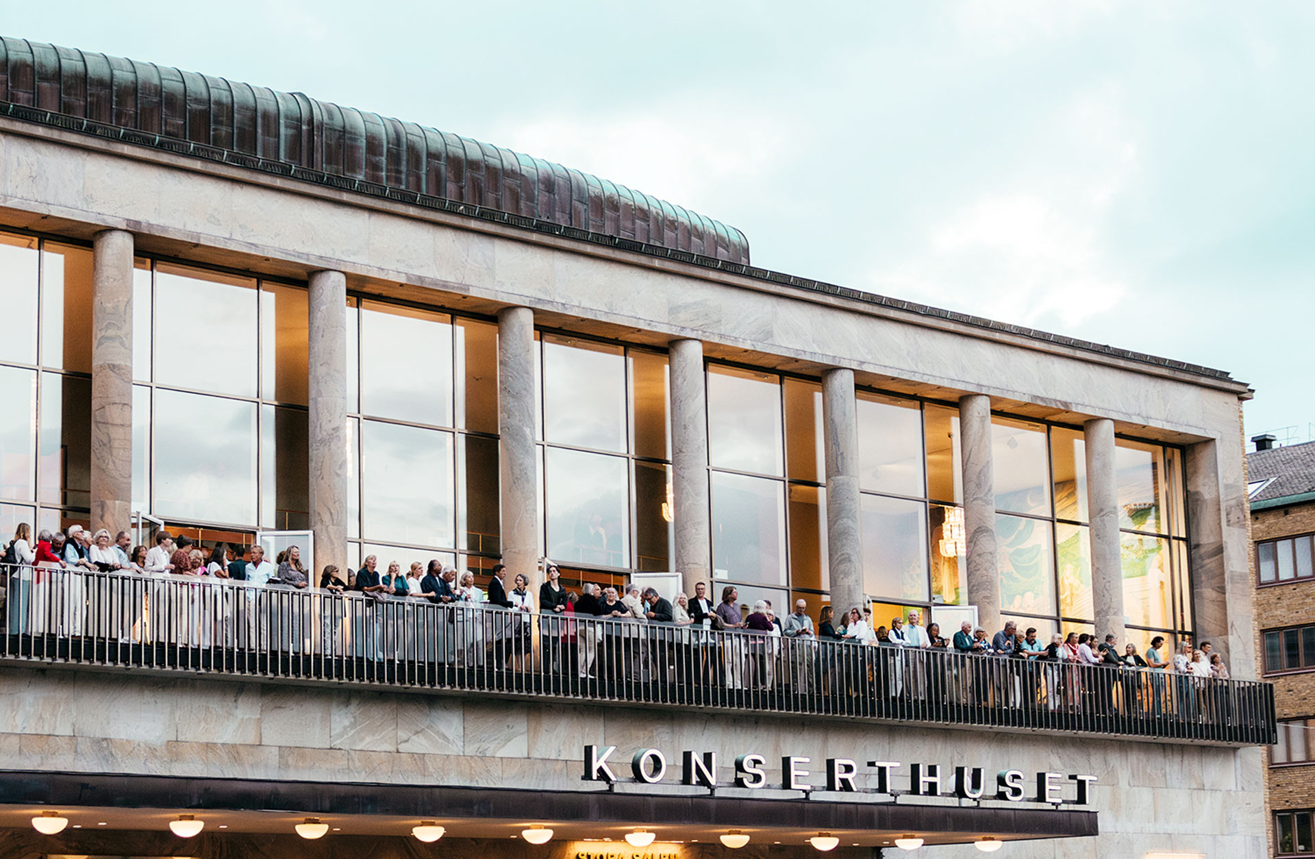 View of the Concert Hall balcony filled with people mingling.